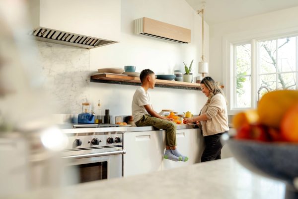 Quilt_IndoorUnit_WhiteOak_Kitchen Wall-mounted ductless mini-split indoor unit in a modern kitchen